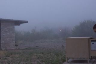 Foggy outdoor area with stone shelter