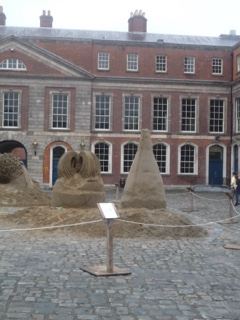 Sand sculptures in courtyard before historic building