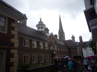 Historic Brick Building With Spire Under Rain