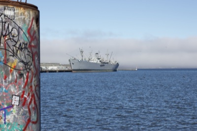 Graffiti Cylinder Overlooking Harbor Ship