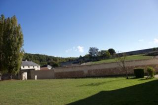 Walled Grass Courtyard Under Clear Sky