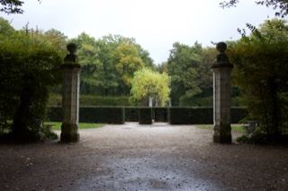Formal Garden Entrance With Stone Pillars