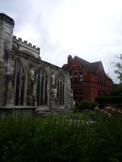 Gothic Church Next to Red Brick Building