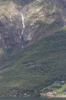 Mountain Waterfall Over Forested Valley