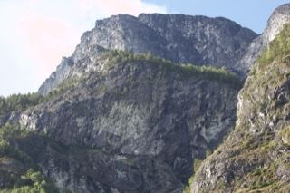 Rugged Mountain Cliff Under Blue Sky