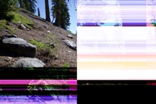 Glitched hillside with rocks and trees