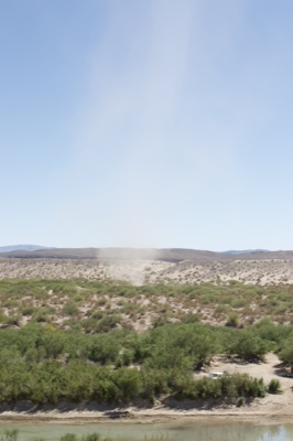 Dust Devil Over Desert Riverbank