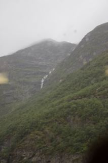 Mist-Shrouded Mountains With Waterfall