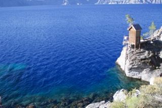 Wooden Hut on Cliff Over Lake