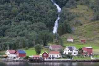 Waterfall Over Fjord Village Houses