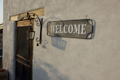 Welcome Sign on Stucco Wall