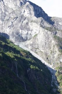 Rugged Mountain Face With Waterfall