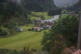 Rural Valley With River And Houses