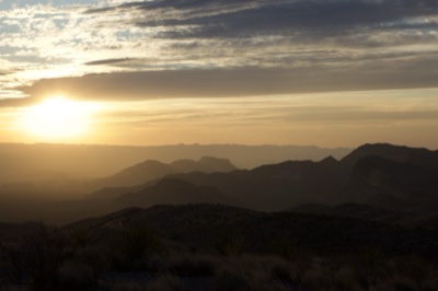 Desert Sunset Over Layered Mountains