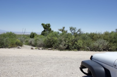 Desert gravel road with white jeep
