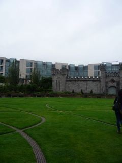 Courtyard Lawn with Castle Wall and Modern Building