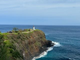 Lighthouse on Coastal Cliff Over Ocean