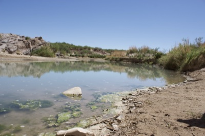 Desert river pool under clear sky