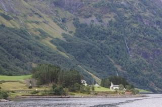 Fjord Valley Farmhouse Under Mountains