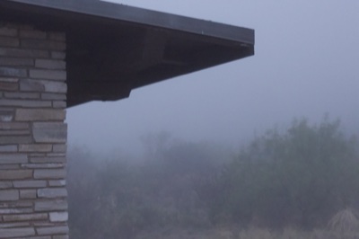 Stone building corner in fog