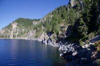 Lake Shore with Forested Mountain Cliff