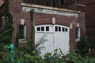 Abandoned Brick Garage With Overgrowth