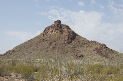 Desert Butte Under Partly Cloudy Sky