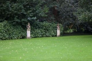 Manicured lawn with statues in garden