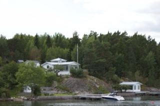 White House on Forested Lake Shore