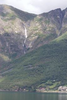 Mountain waterfall over fjord lake