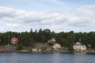 Coastal houses on forested shoreline