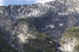 Rugged Mountain Cliff With Waterfall