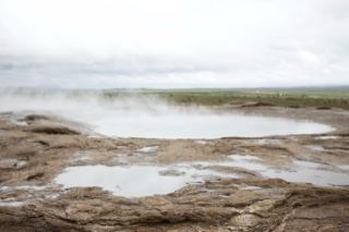 Steaming Geothermal Pool in Overcast Landscape