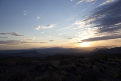 Desert Sunset Over Distant Mountains