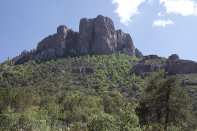 Rugged Mountain Peak Over Forested Hills