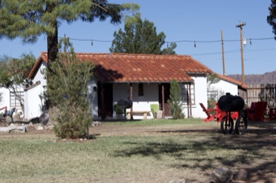 Southwestern Adobe House With Red Wagon