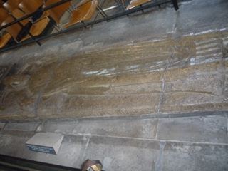 Medieval stone effigy on church wall
