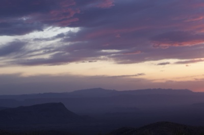 Purple Sunset Over Distant Mountains