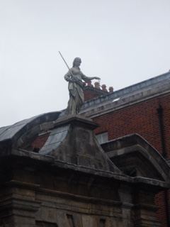 Statue atop historic building roof